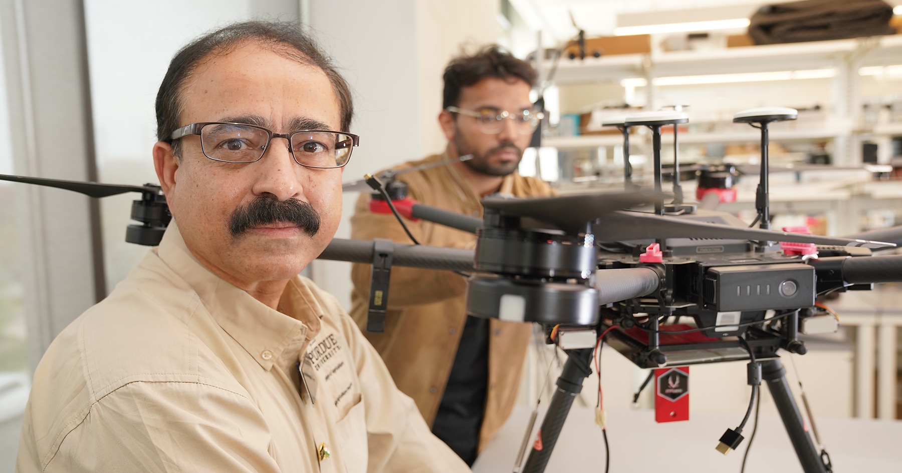 Dharmendra Saraswat works with student and drone.
