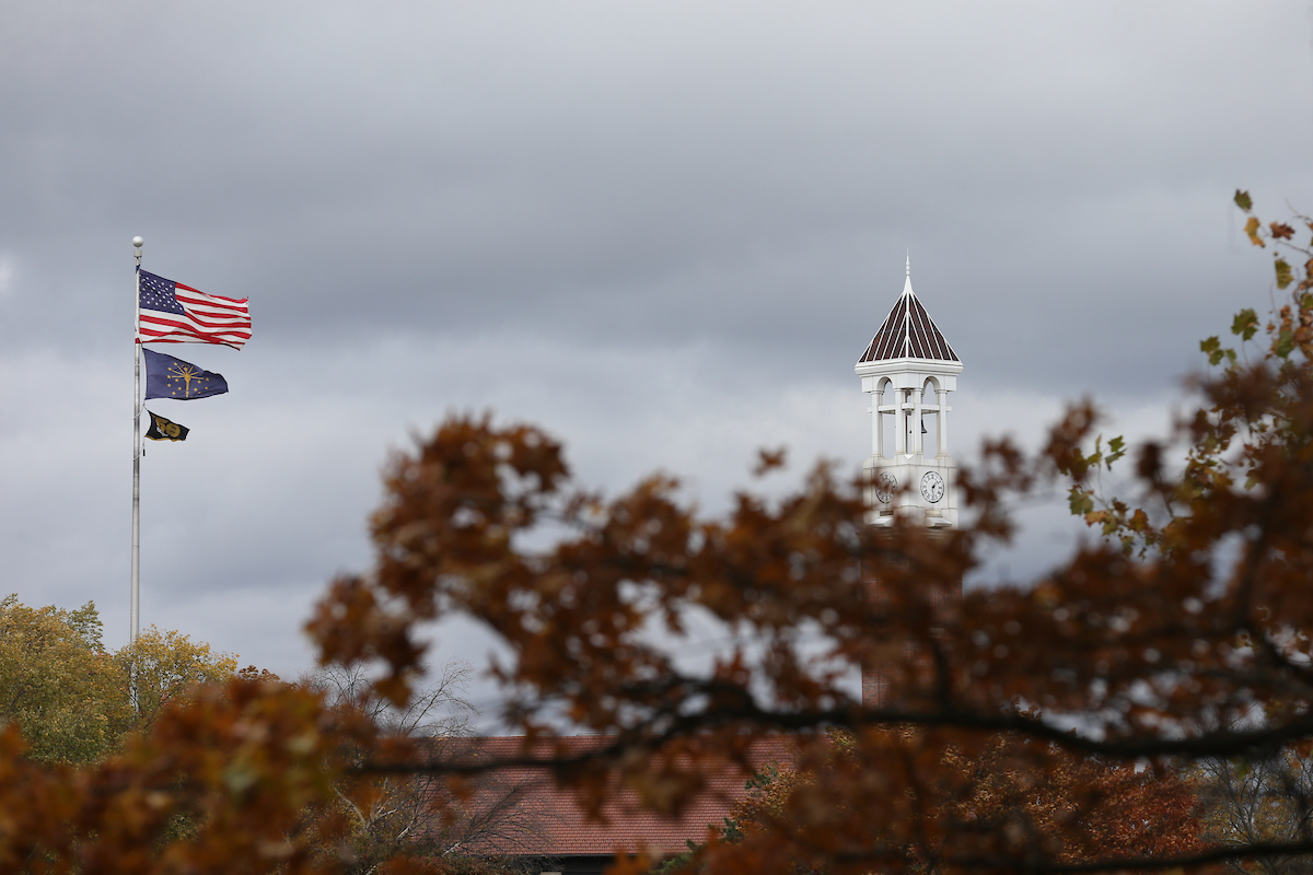 The Purdue Bell Tower peeks over fall foliage