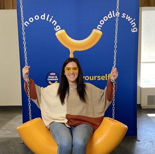 Bridget McClatchey sits on macaroni swing