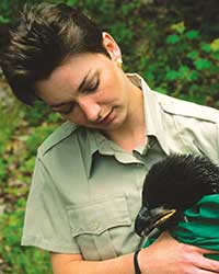 Naturalist examining bird