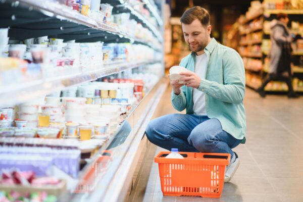 Person reading food label in grocery store