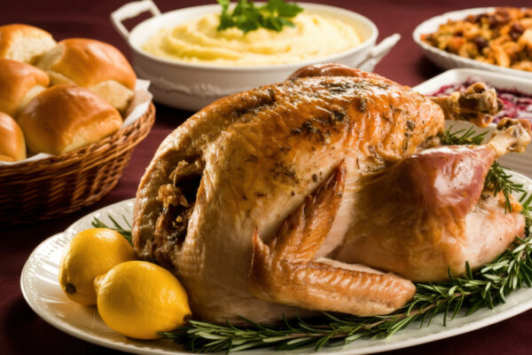 Thanksgiving meal items: turkey, mashed potatoes and rolls.