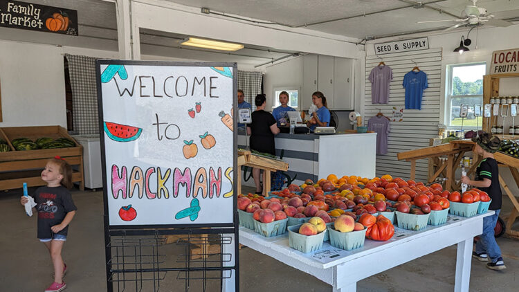 "Welcome to Hackmans" sign inside the produce store at the Hackman Family Farm Market during the Purdue Farm Management Tour on July 11, 2023.