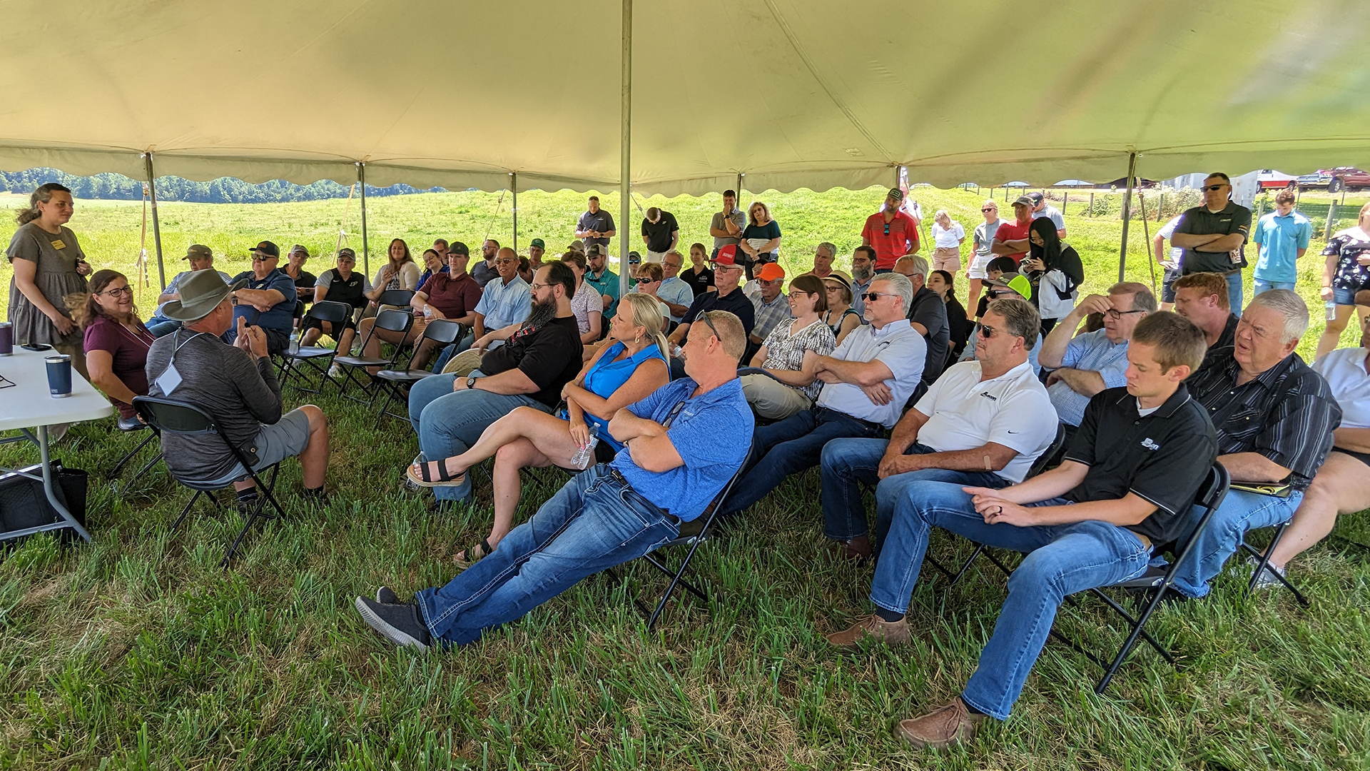 Crowd listening under a tent during the Purdue Farm Management Tour on July 11, 2023.