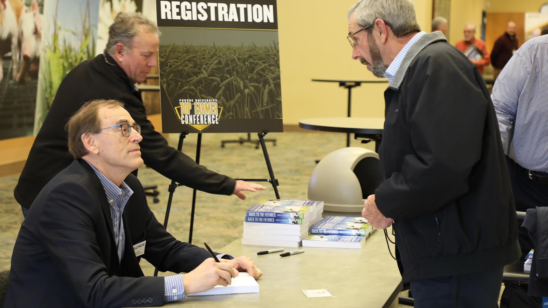 Scott Irwin signing his books at the Purdue Top Farmer Conference on January 5, 2024.