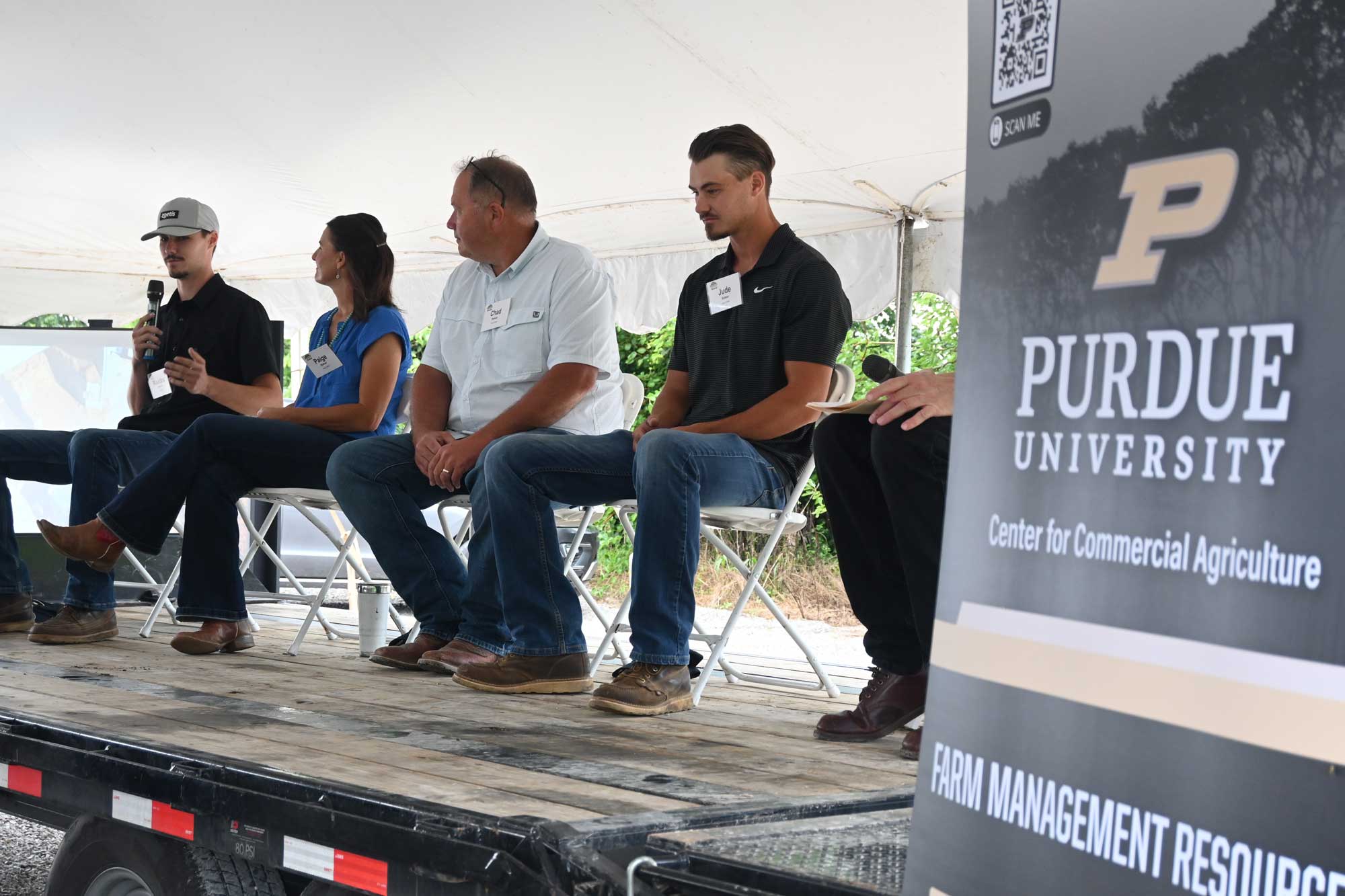 Maddox, Paige, Chad, and Jude Baker speaking during the Purdue Farm Management Tour