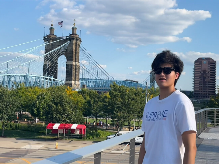 Zhang in front of NYC bridge