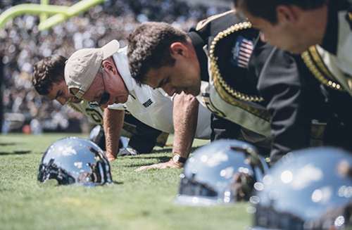 drum crew doing pushups on field