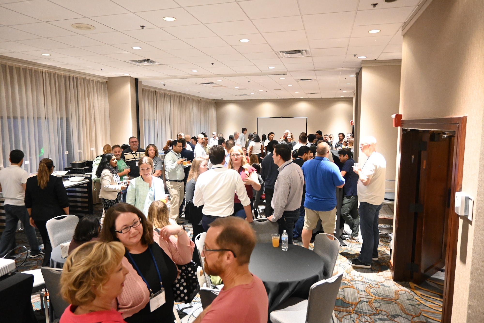 Group of Purdue alumni, students, faculty and staff gathered in a reception room