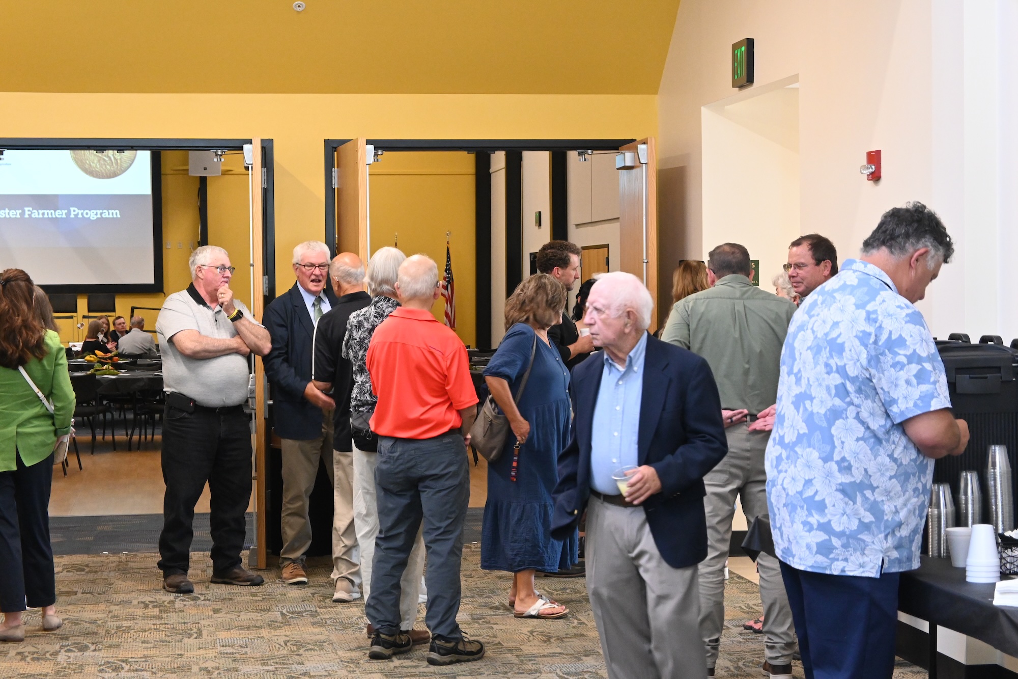 Master Farmer ceremony attendees talking in the hall of the Beck Agricultural Center