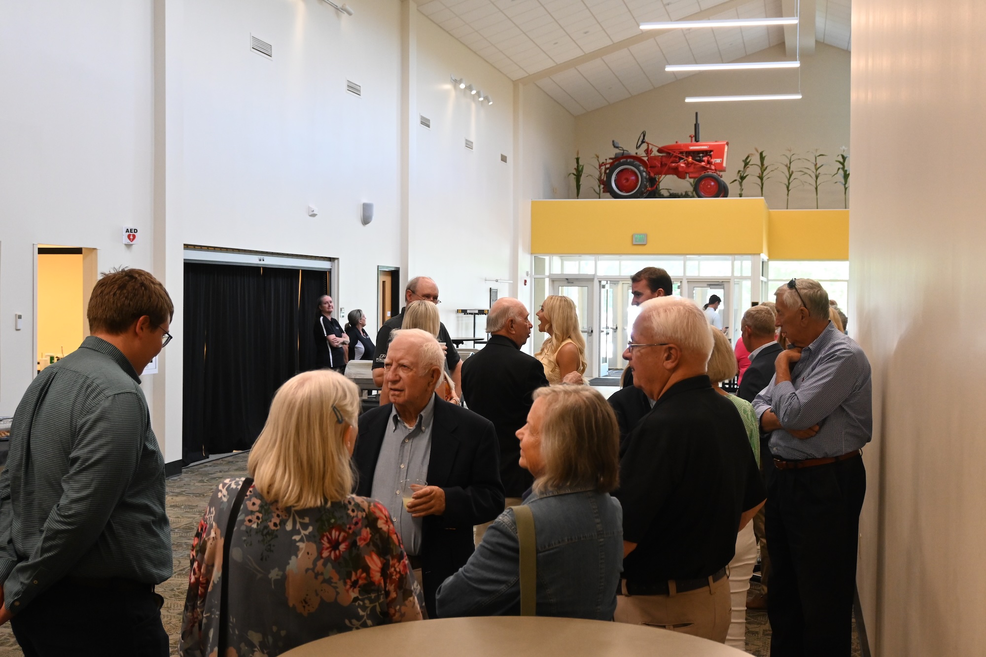 Master Farmer ceremony attendees talking in the hall of the Beck Agricultural Center