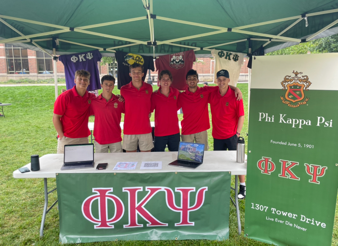 Grant Bell standing with his fraternity brothers