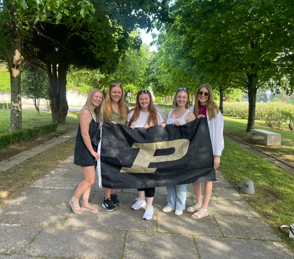 King with friends and Purdue flag