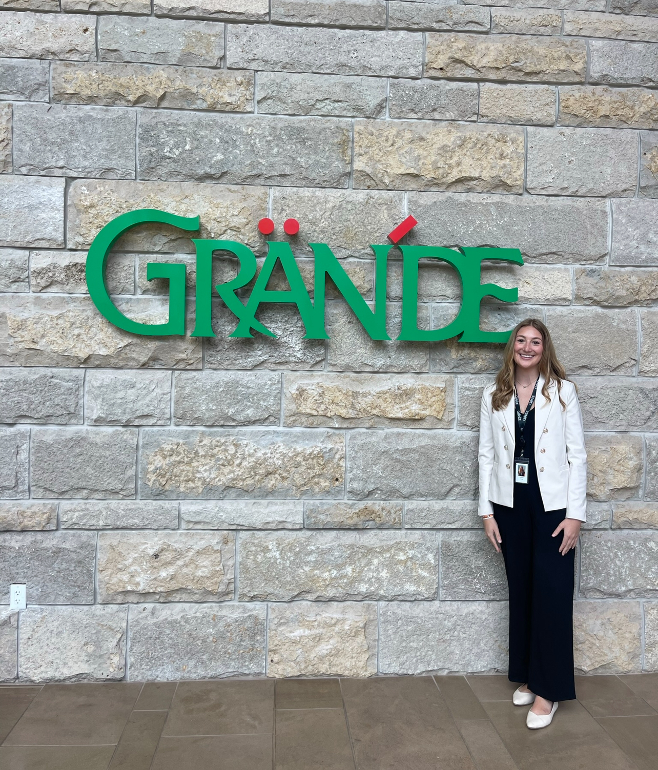 King in front of Grande Cheese Company sign