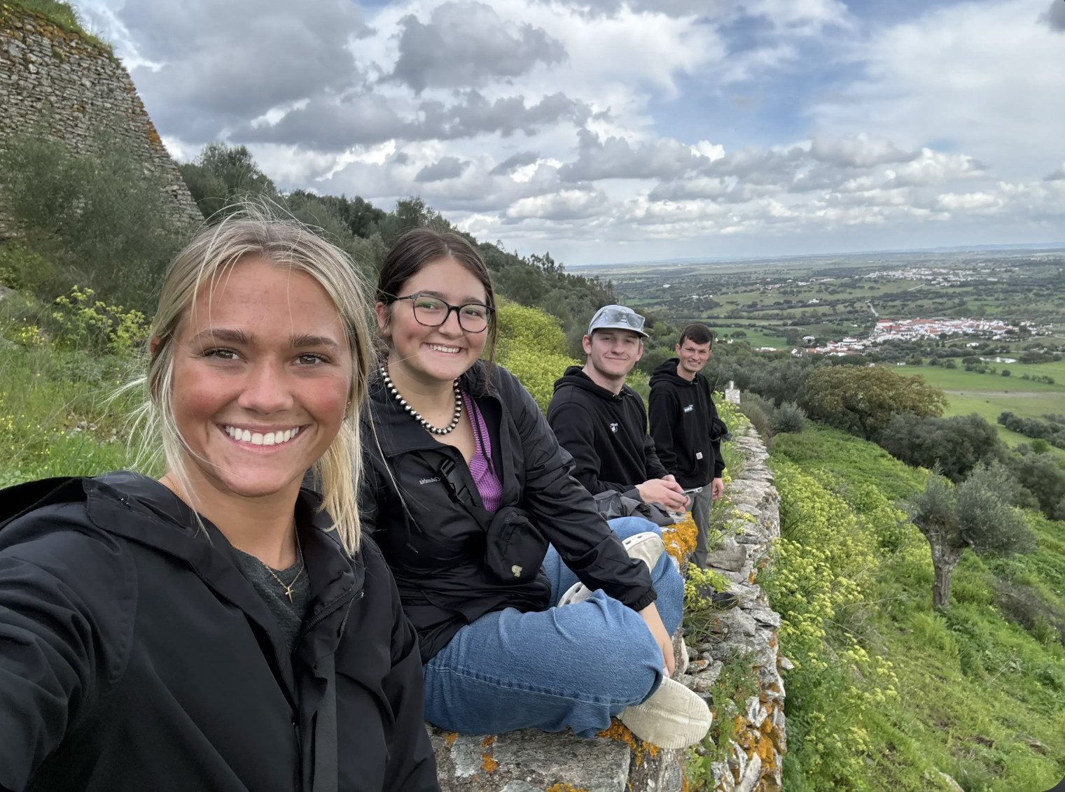 Madison sitting on a wall with friends