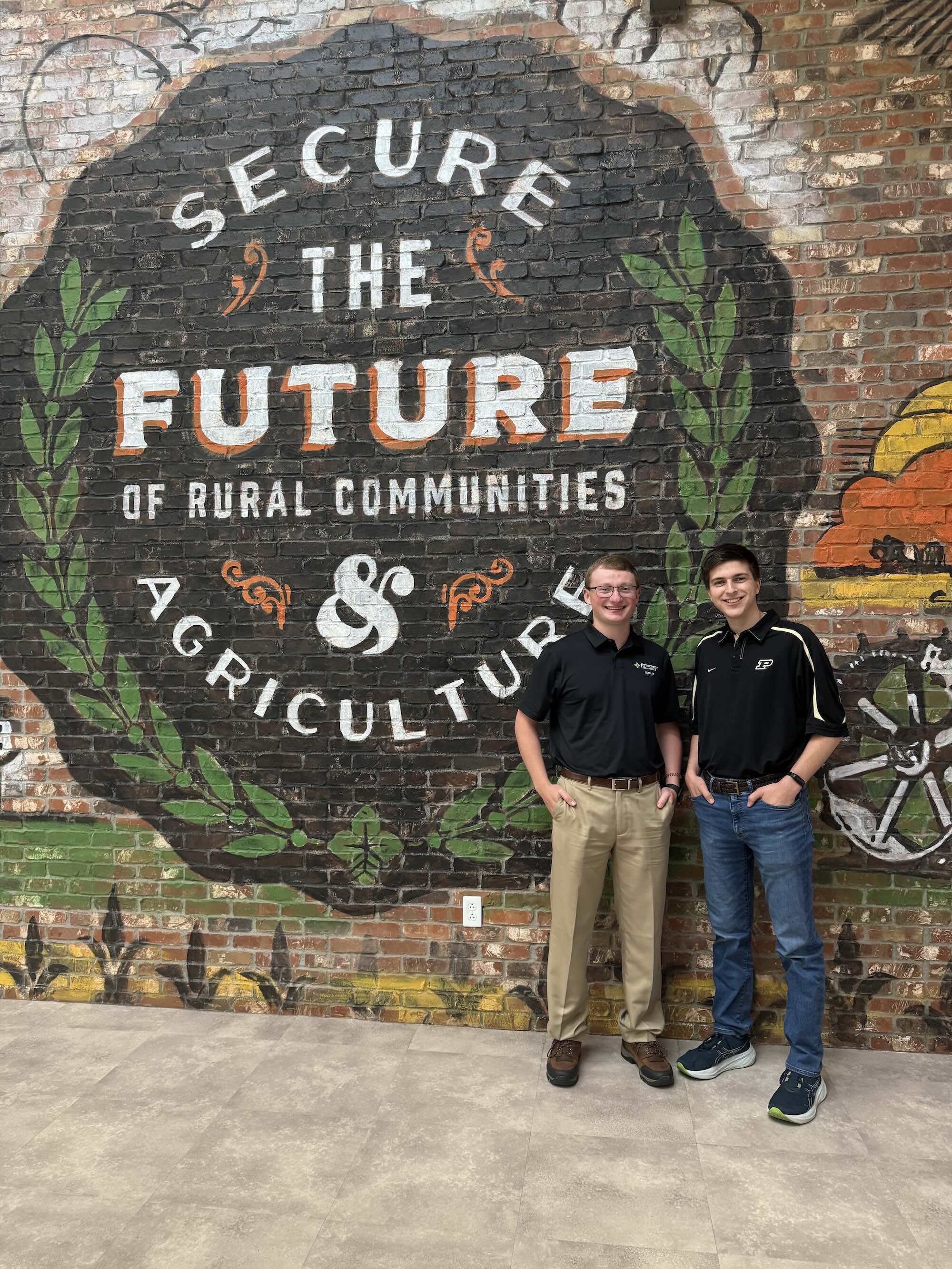 Thompson in front of ag mural