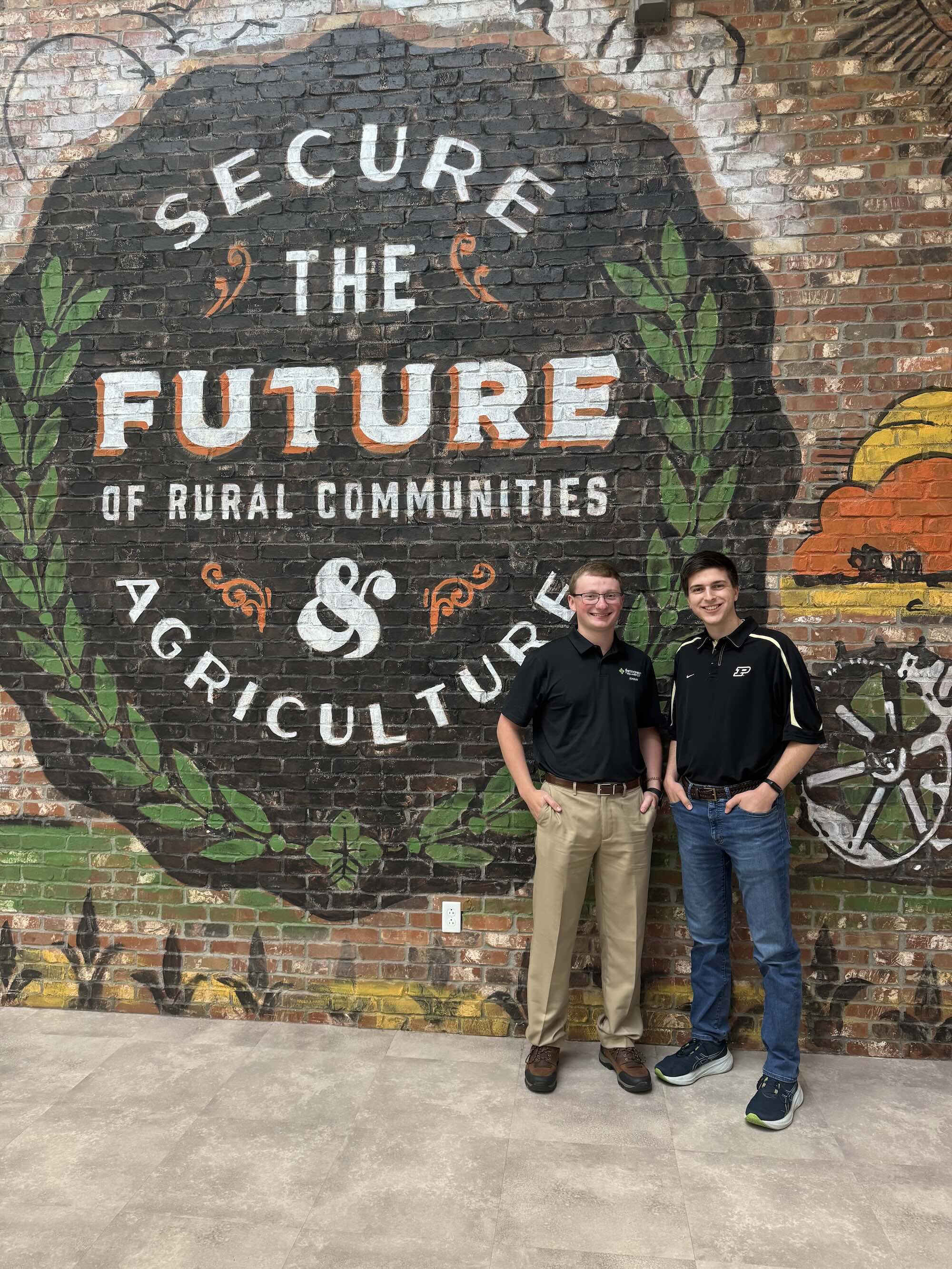 Voll in front of ag mural