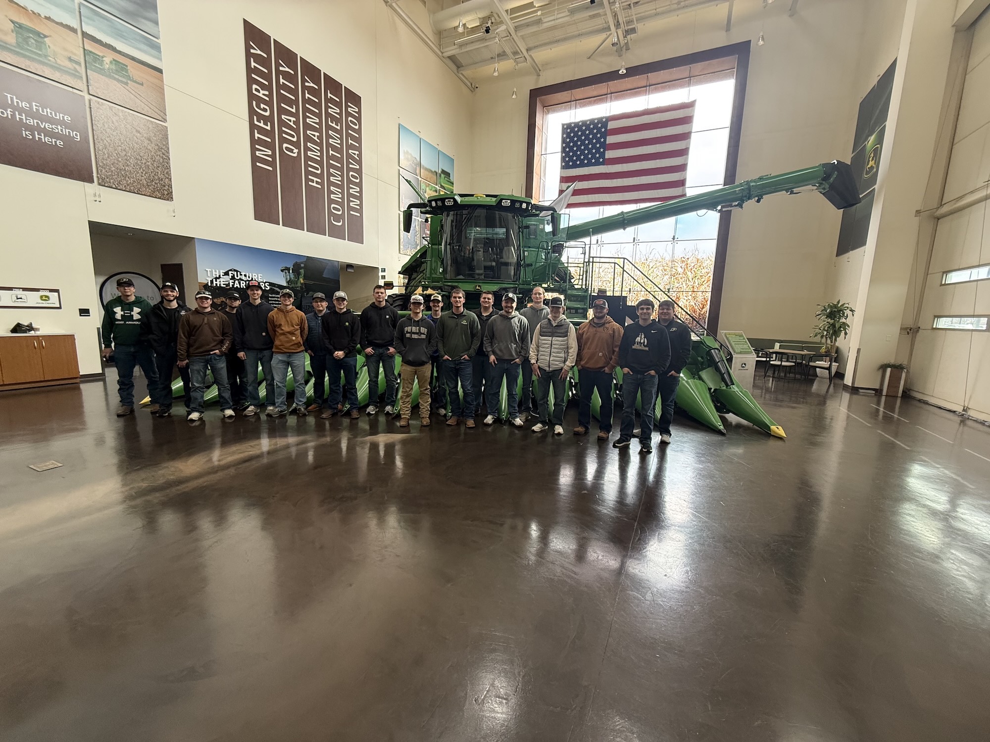 Alberring with students in front of John Deere tractor