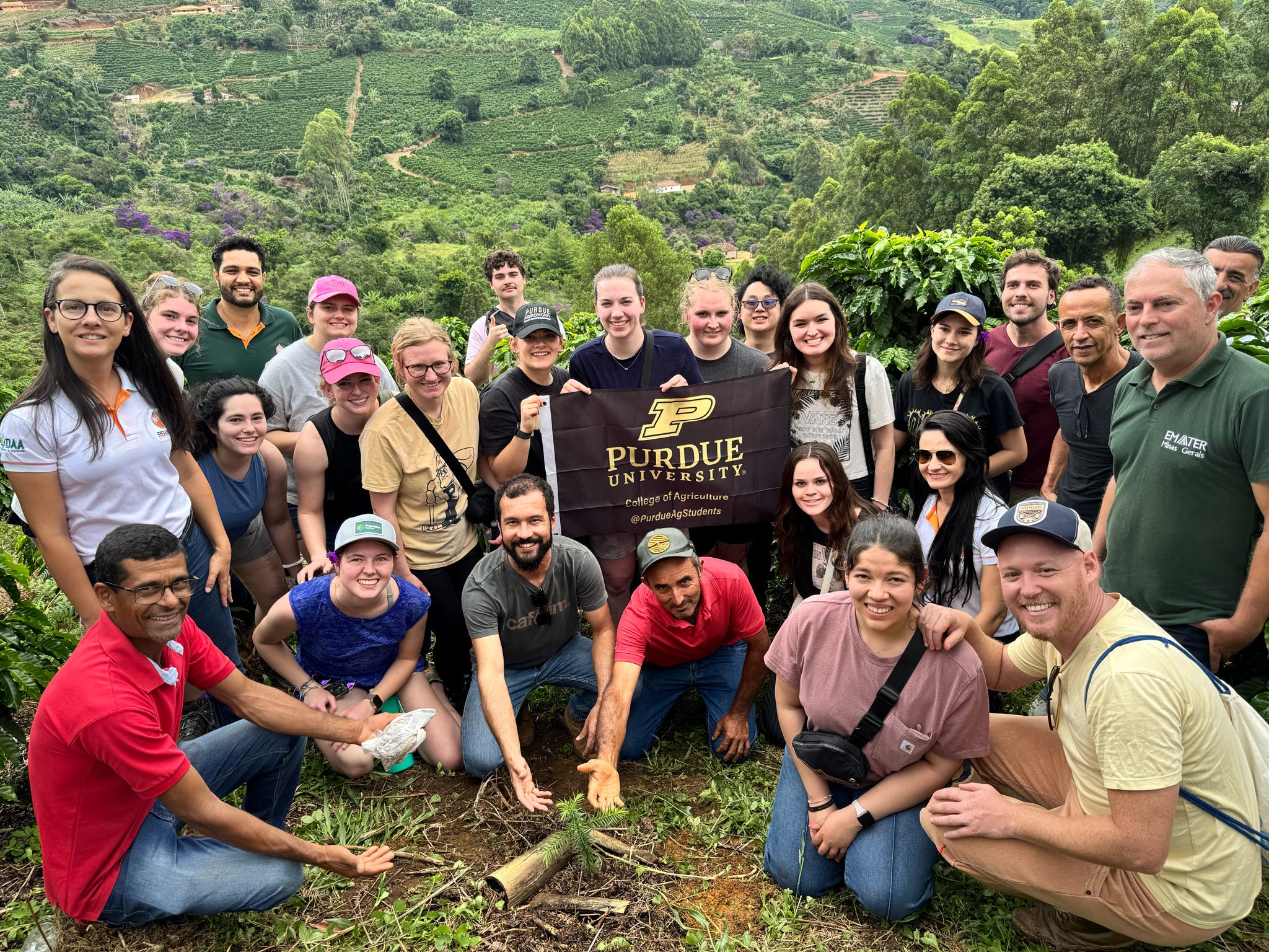 Clary with study abroad group in Peru with Purdue banner