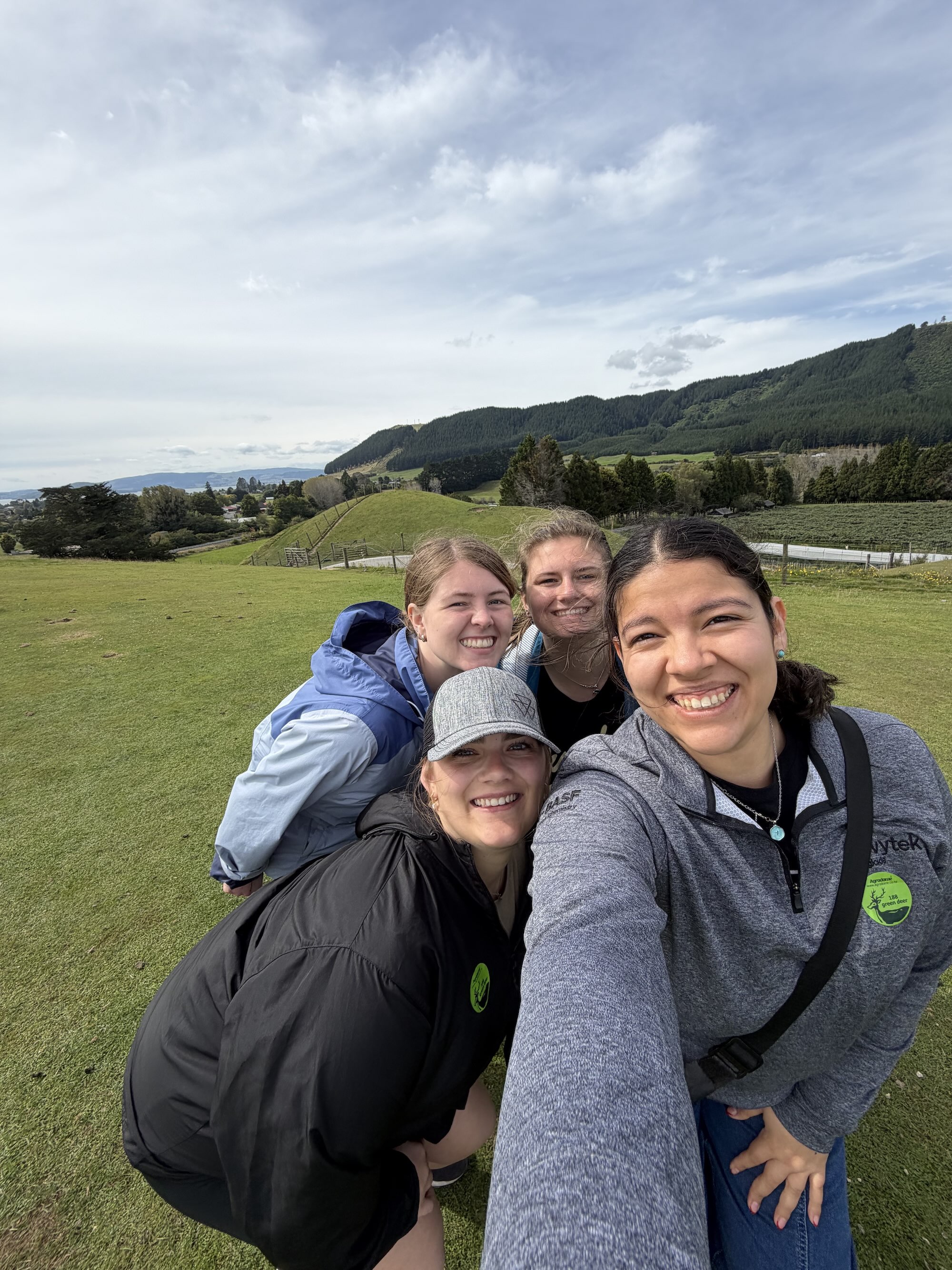 Berenize standing with friends in a field on a study abroad trip