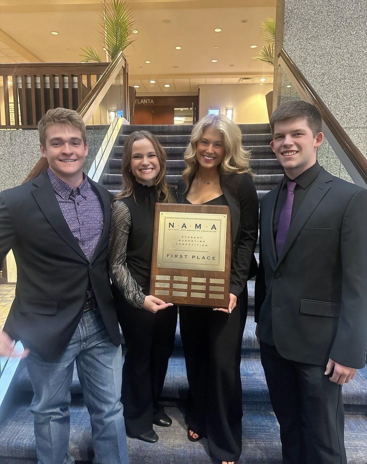 Fitzmorris holding NAMA plaque with teammates
