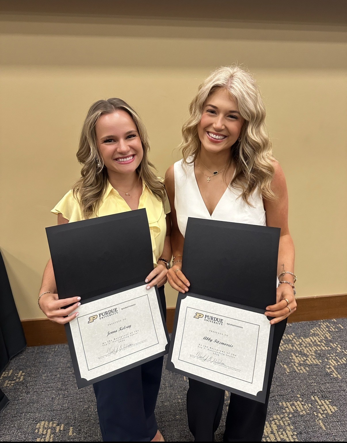Fitzmorris standing with Jenna Kelsay holding a certificate