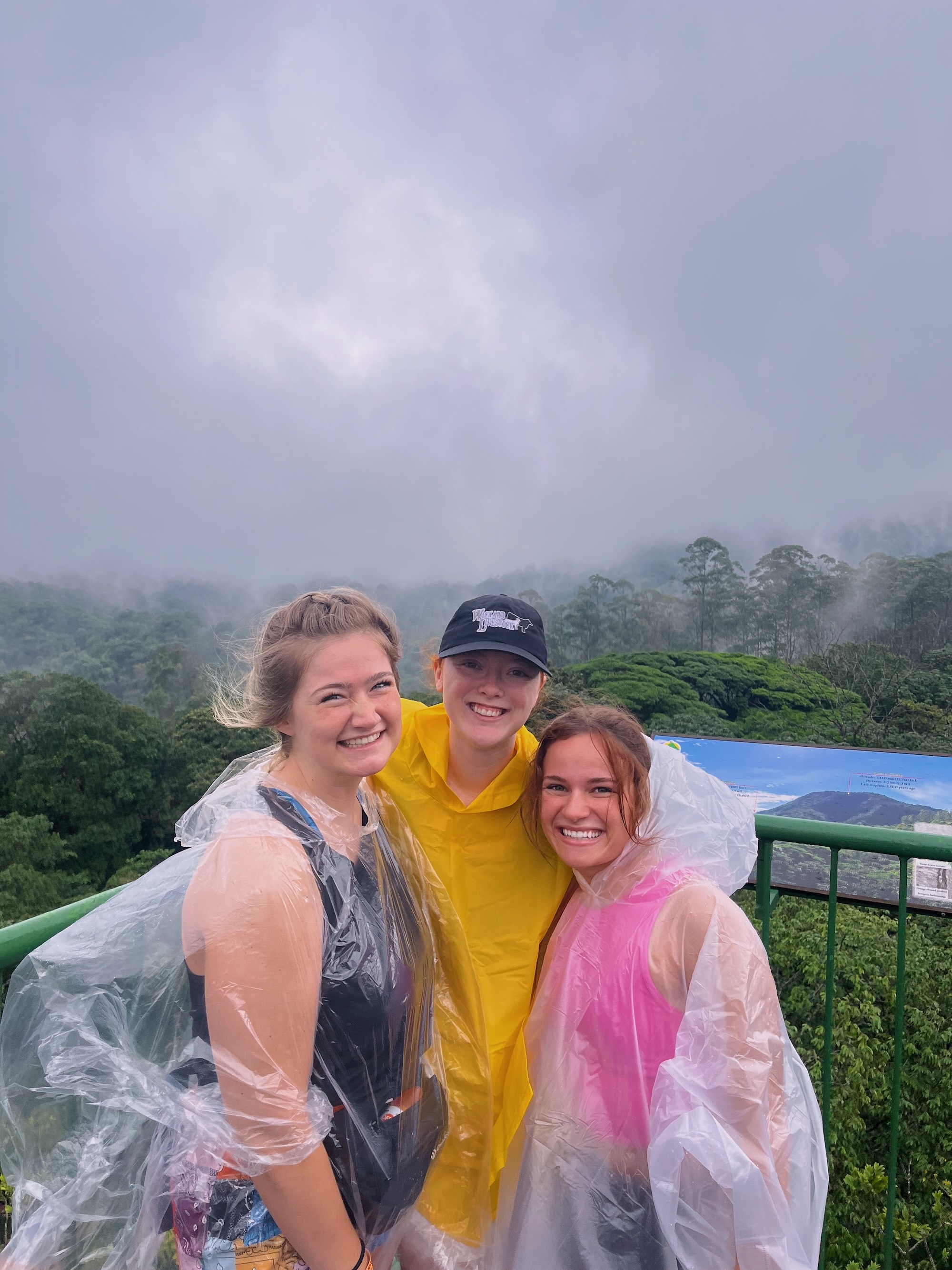 Kelsay with friends dressed in rain gear in Costa Rica 