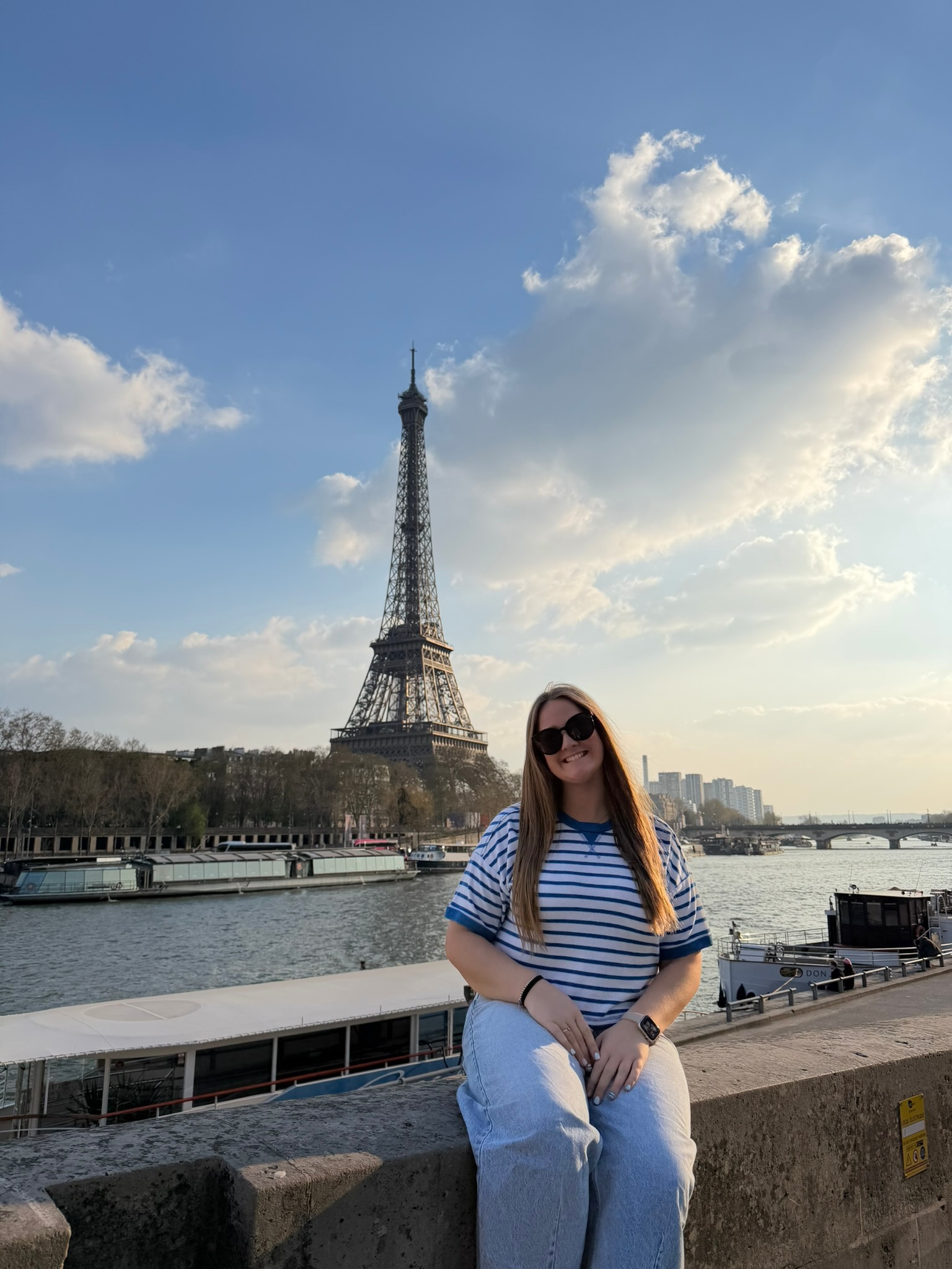 Klinkhamer sitting in front of river with Eiffel Tower in the background