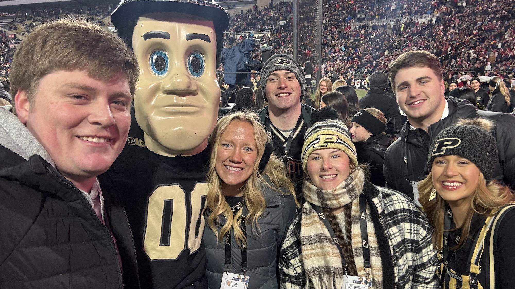 Koester with friends and Purdue Pete at a football game