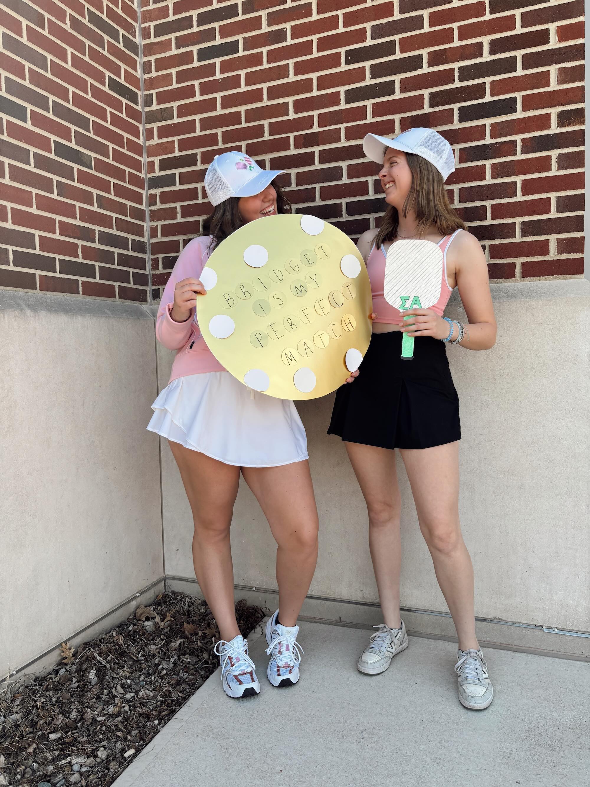 Phillips standing with friend holding pickleball gear