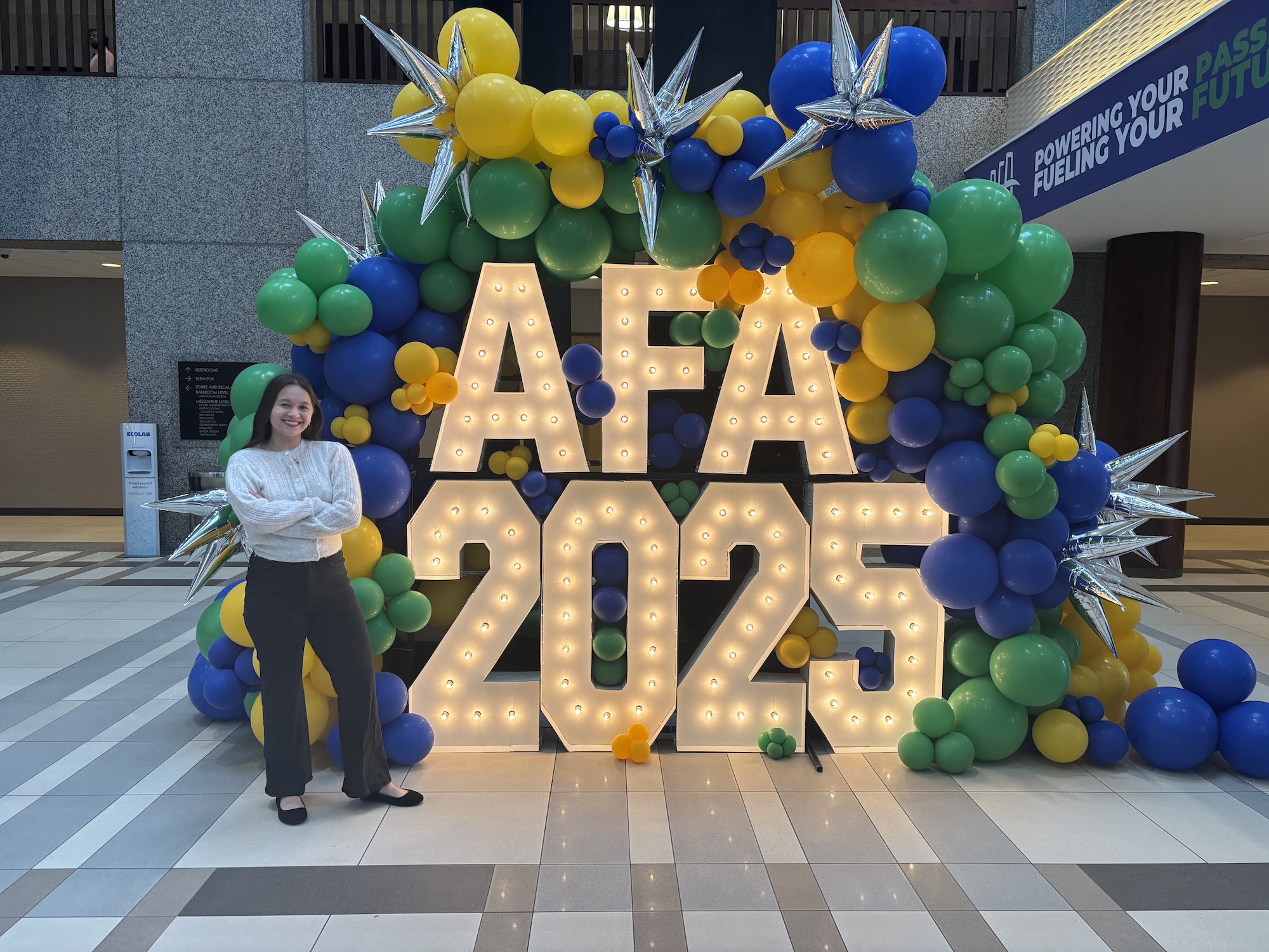 Piliang standing in front of AFA 2025 sign