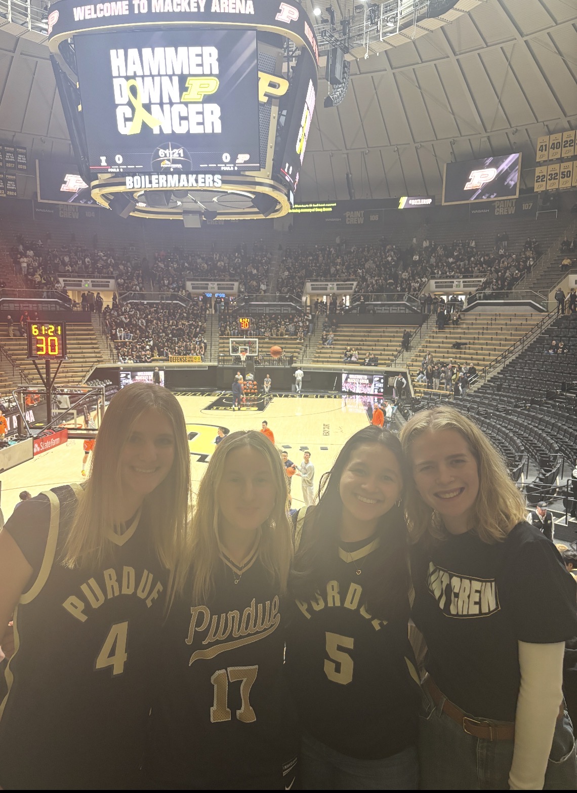 Piliang standing with friends in Mackey Arena