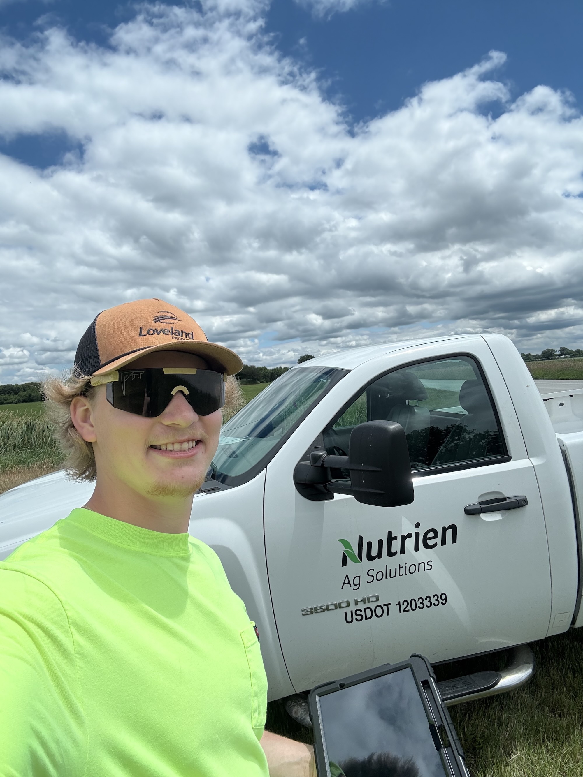 Quale in front of a Nutrien truck during his internship
