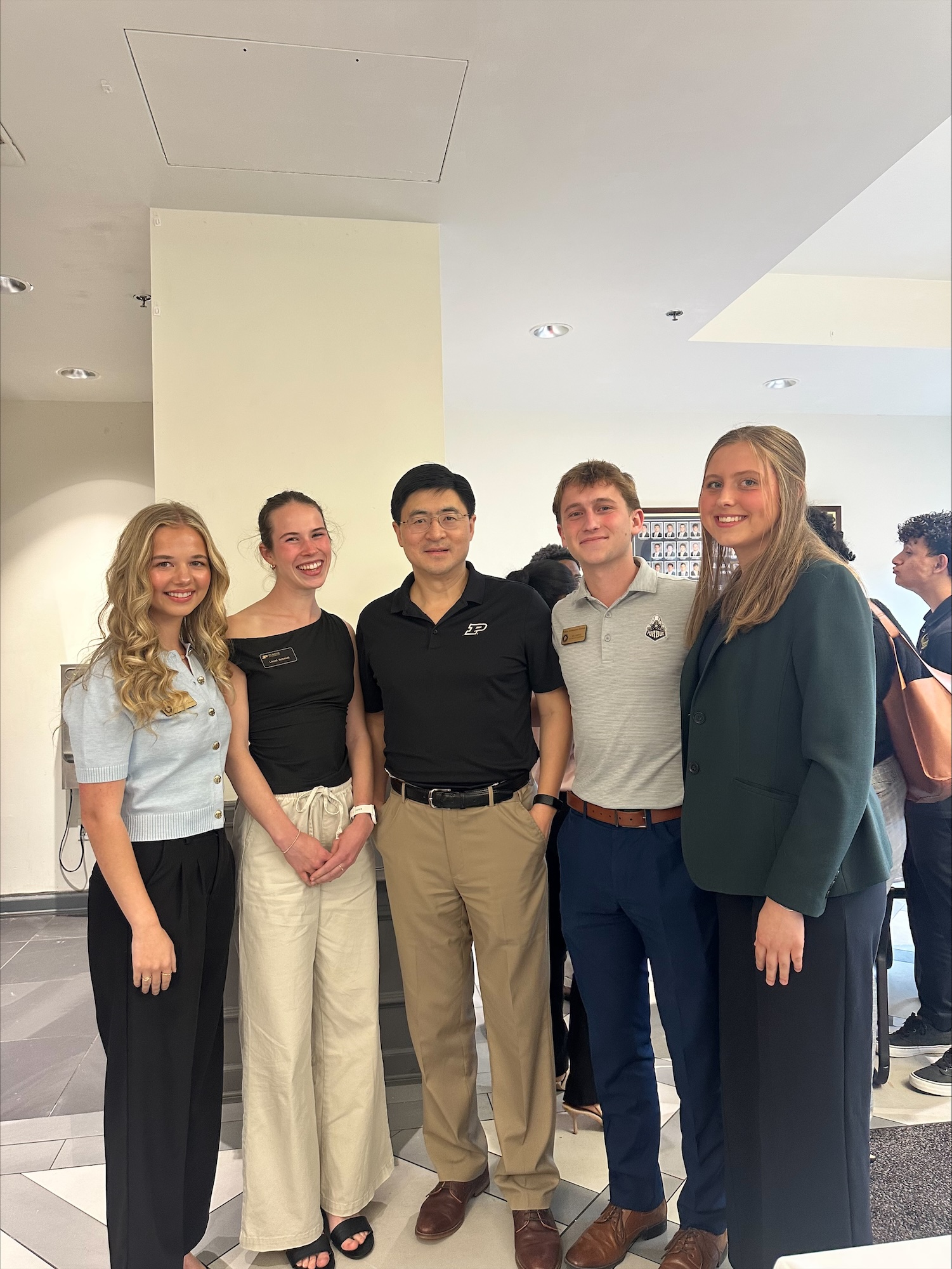 Recker standing with friends and Mung Chiang
