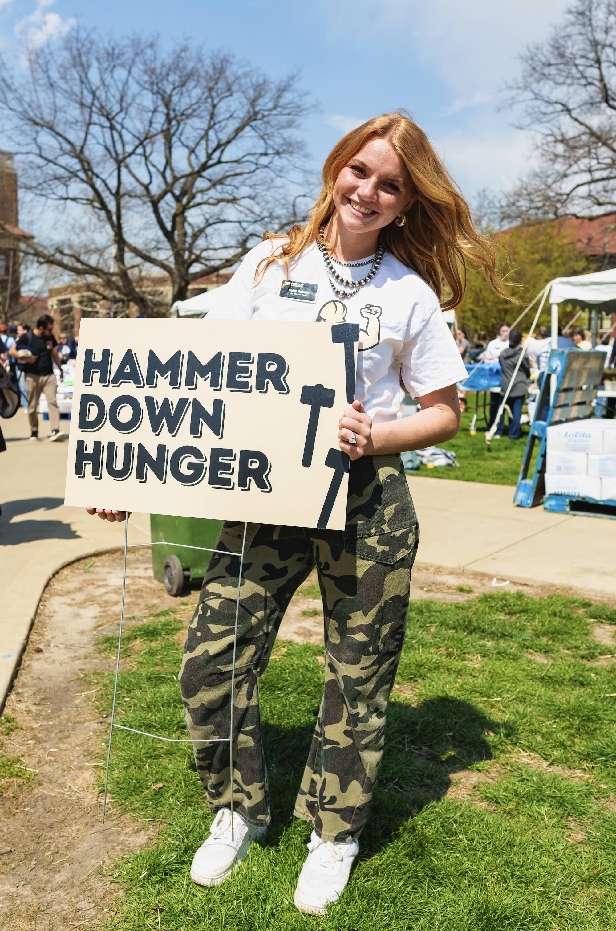 Roberts holding Hammer Down Hunger sign
