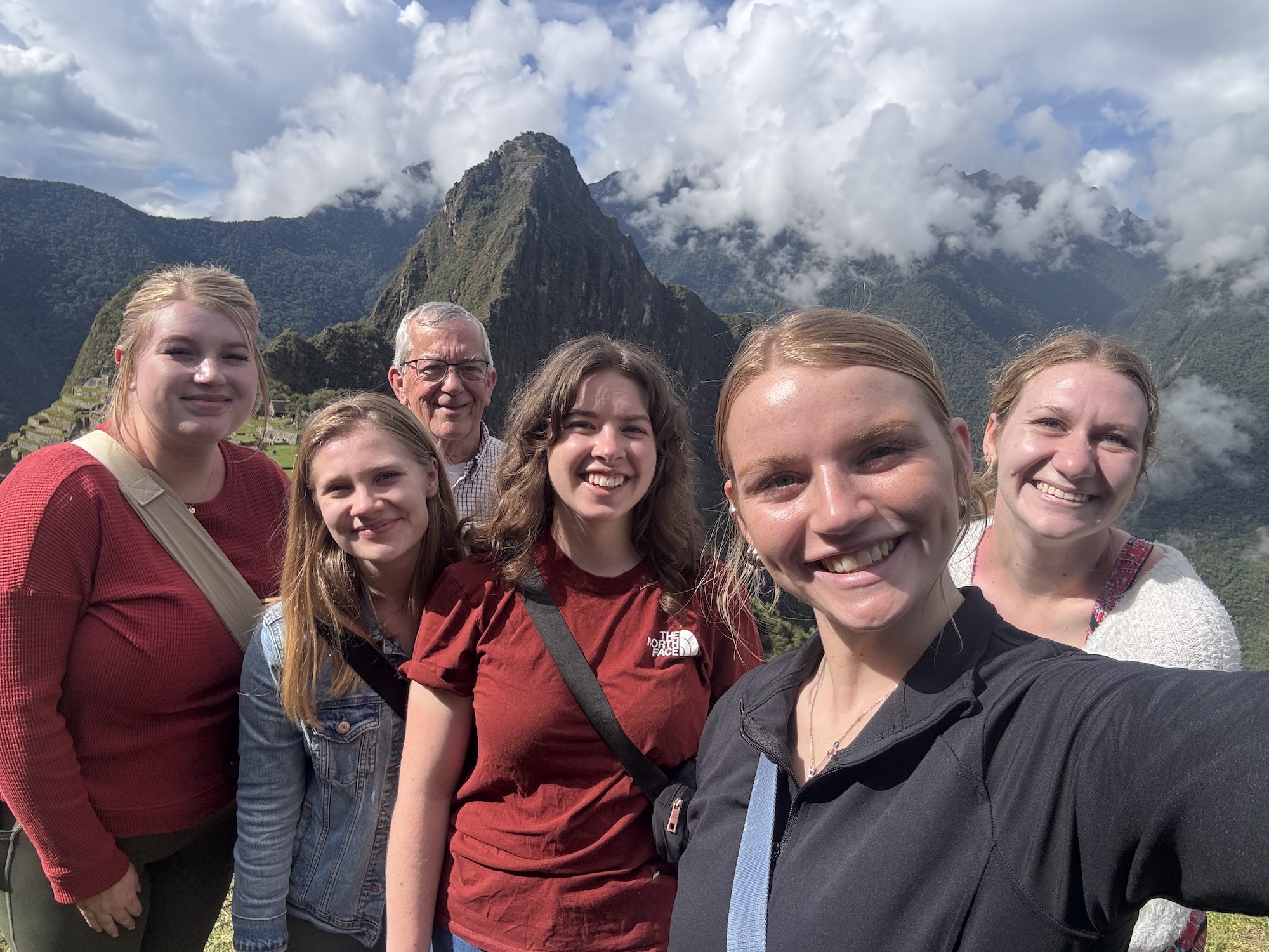 Roberts with peers in front of mountains abroad