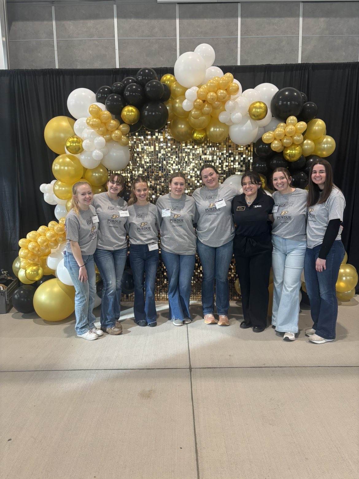 Saathoff with friends in front of balloon arch