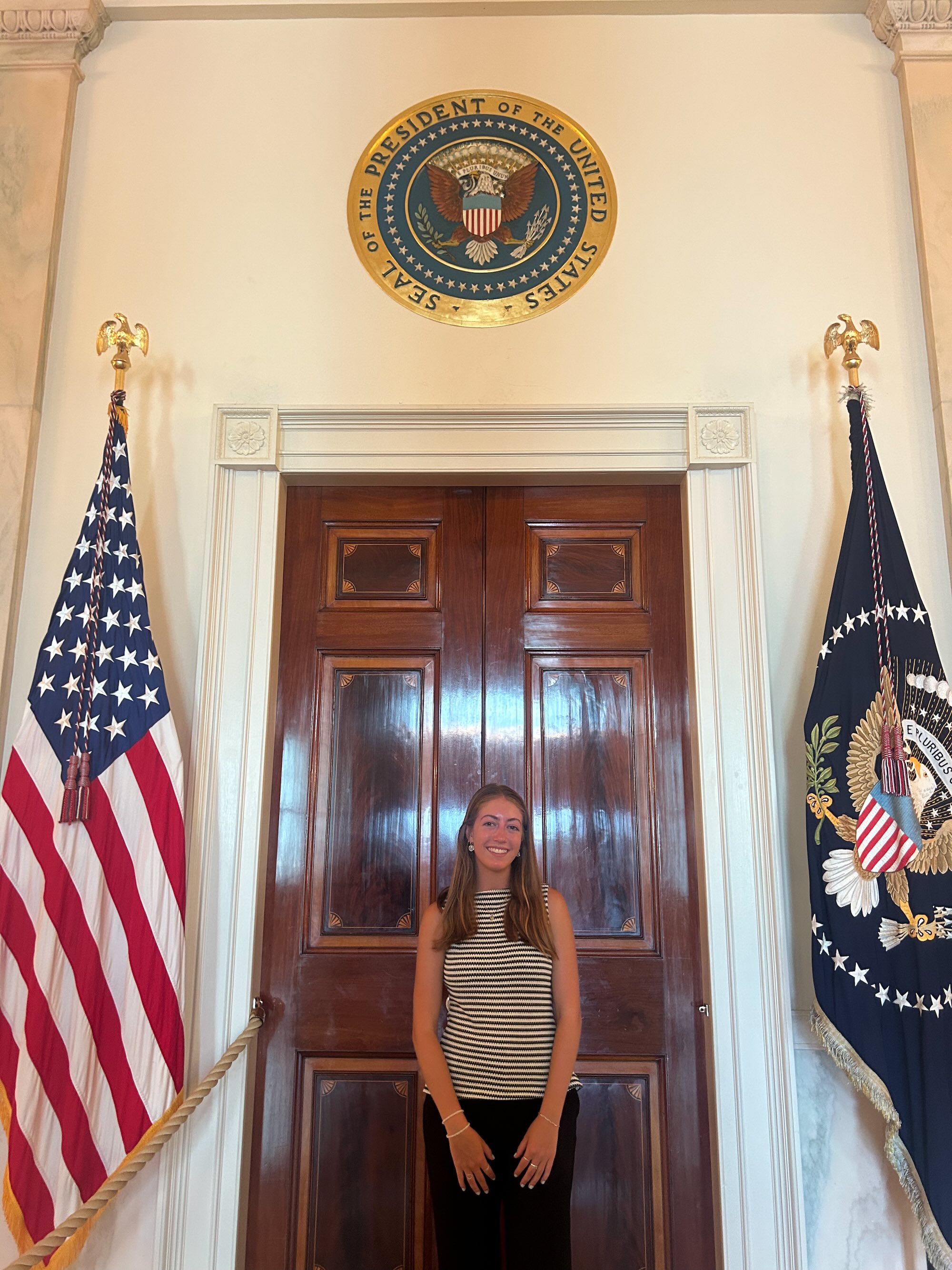 Sheward standing in front of White House president door