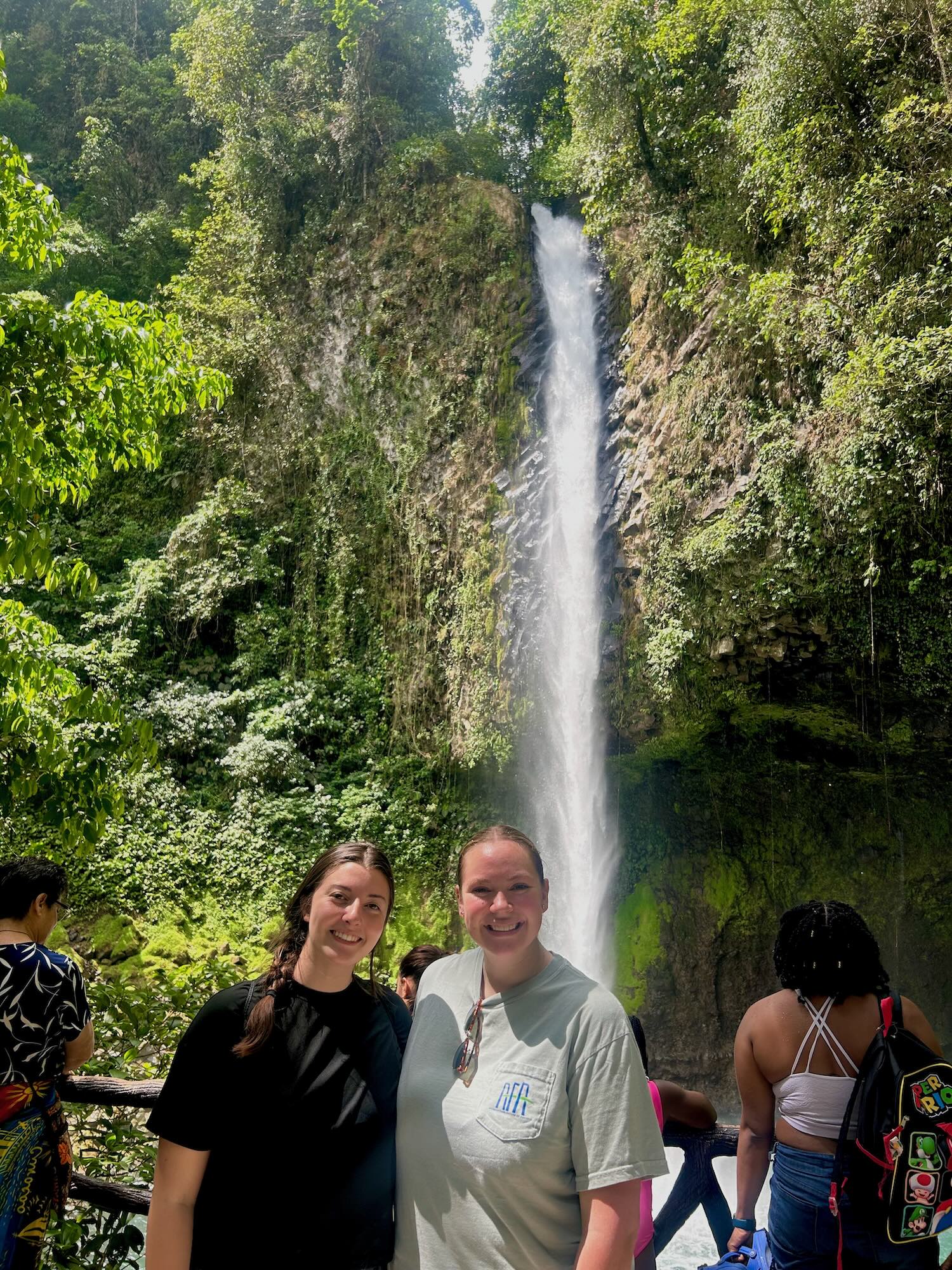 Livingston and friend in front of waterfall