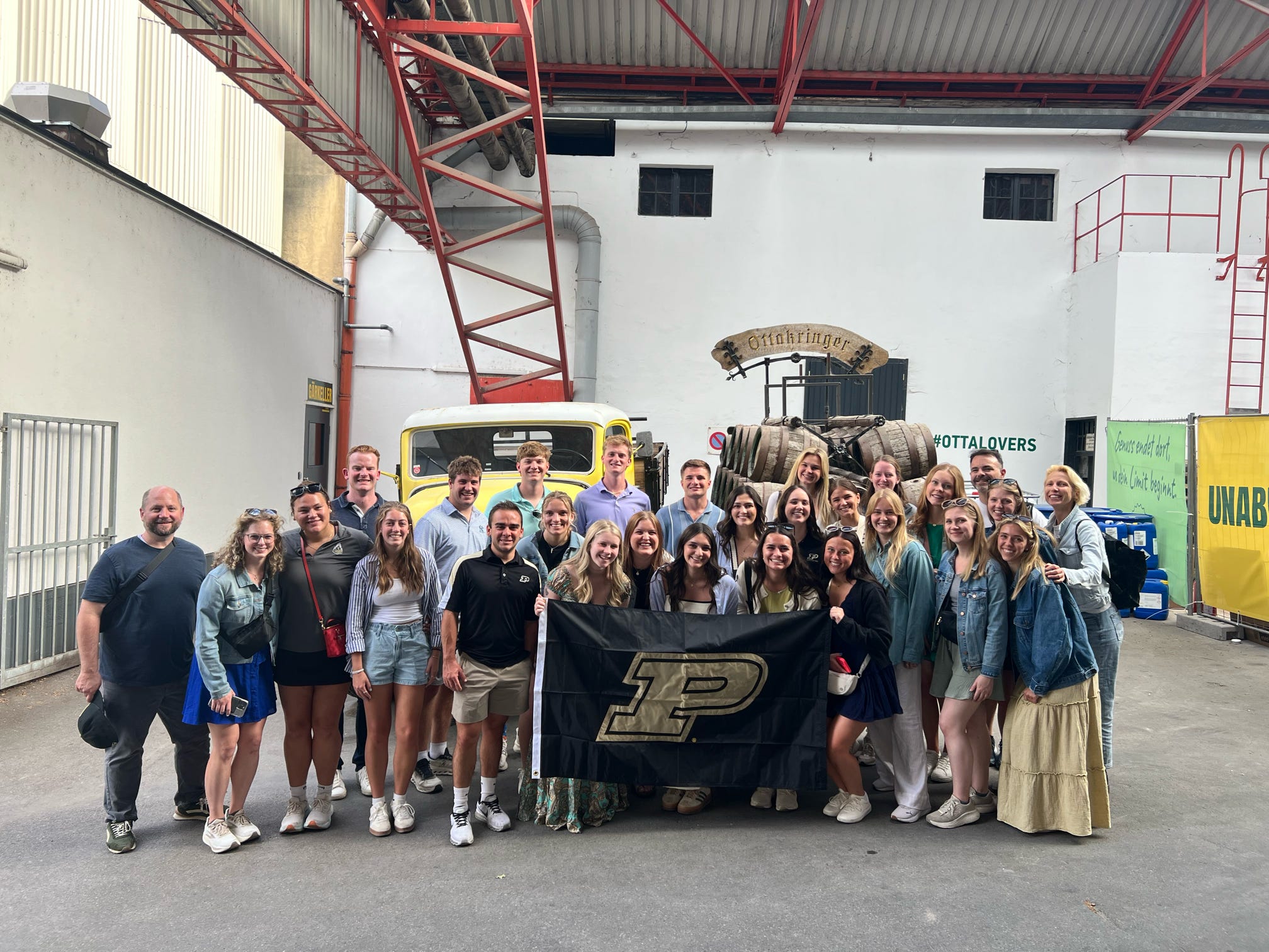 Group with the Purdue flag in a brewery