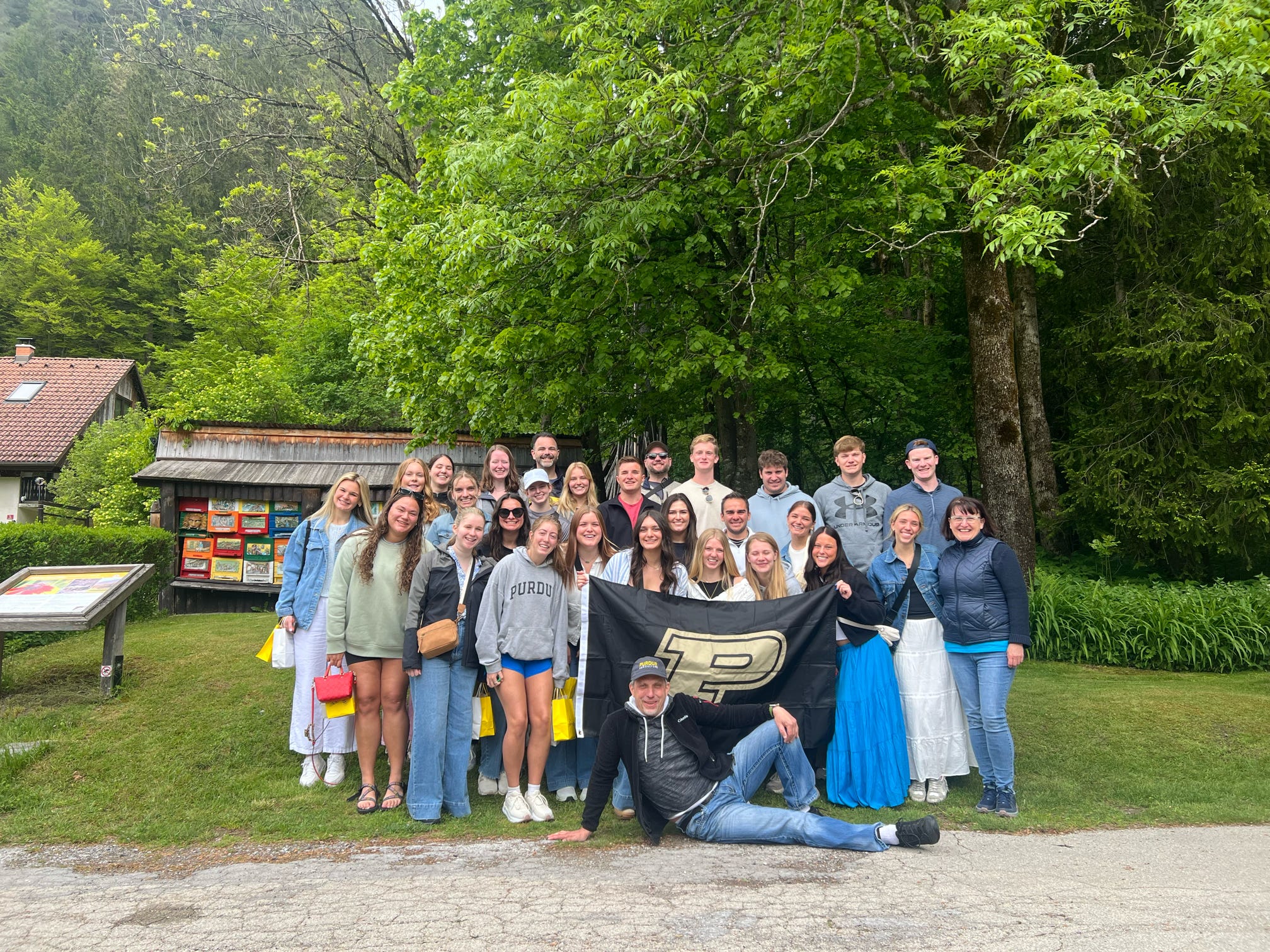 Group with Purdue flag in nature