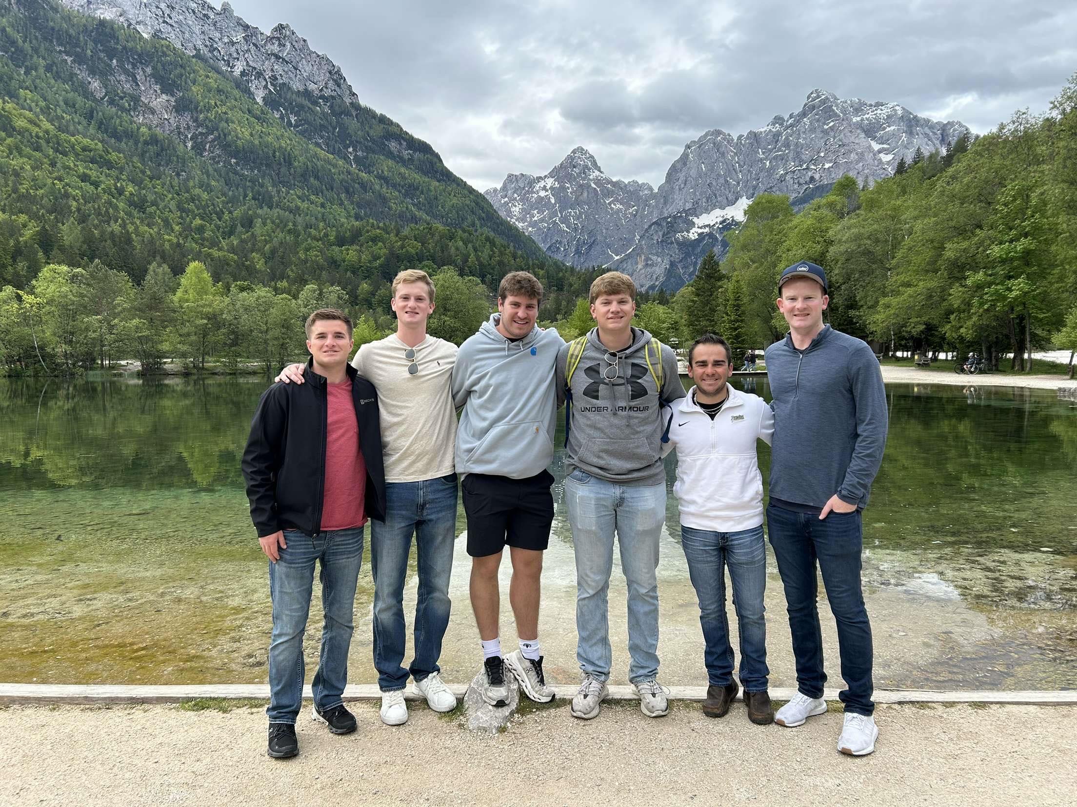 Group of guys by mountains and the lake