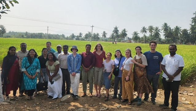 Abi Bothwell with group of travelers and Indian farmers