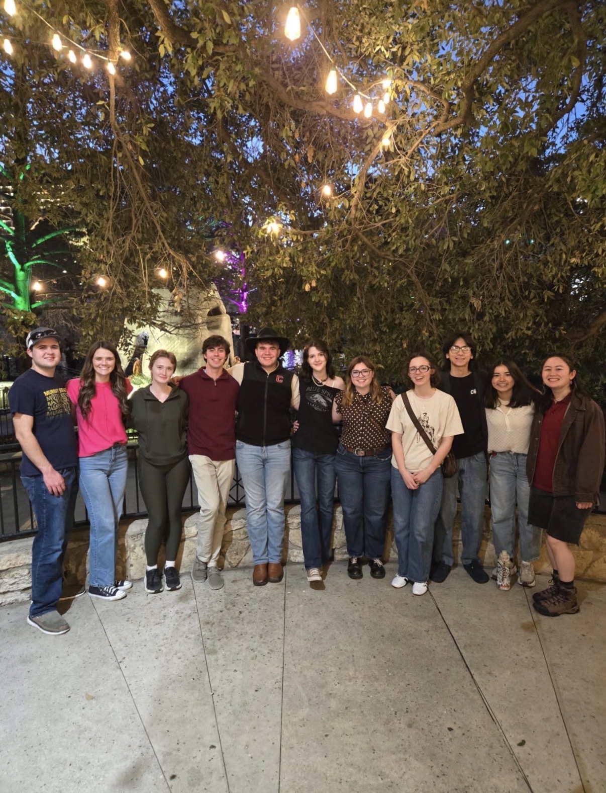 Students at AFA Sustainability in front of trees and lights