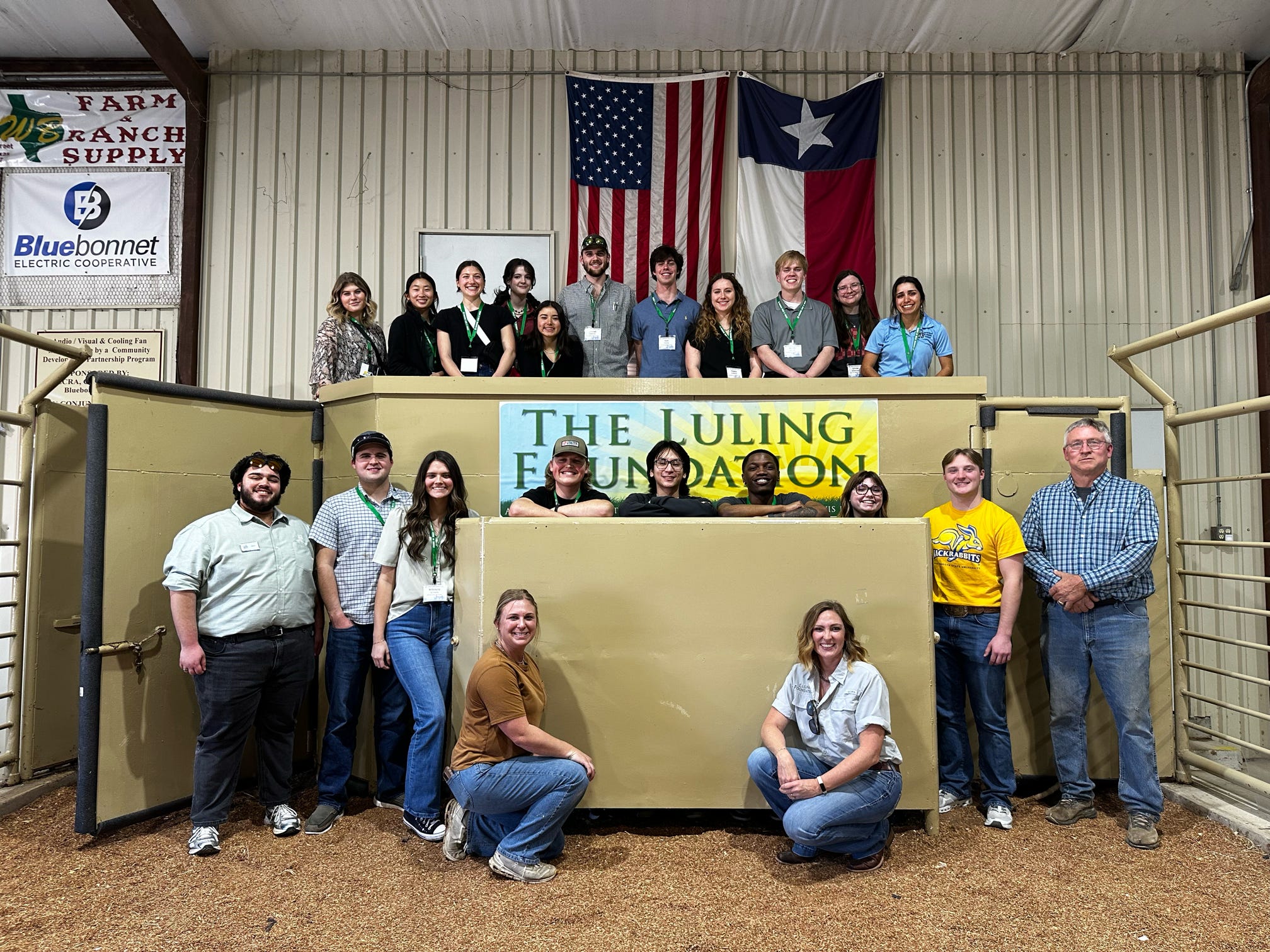 Group of students at AFA Sustainability standing in a cattle pen