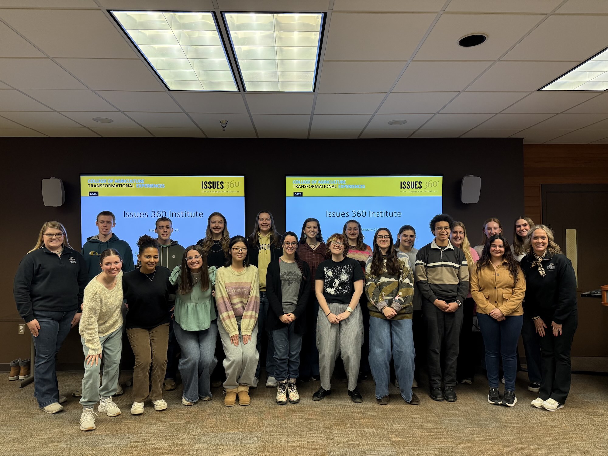 The 2026 Issues 360 group posing for a photo in front of a PowerPoint