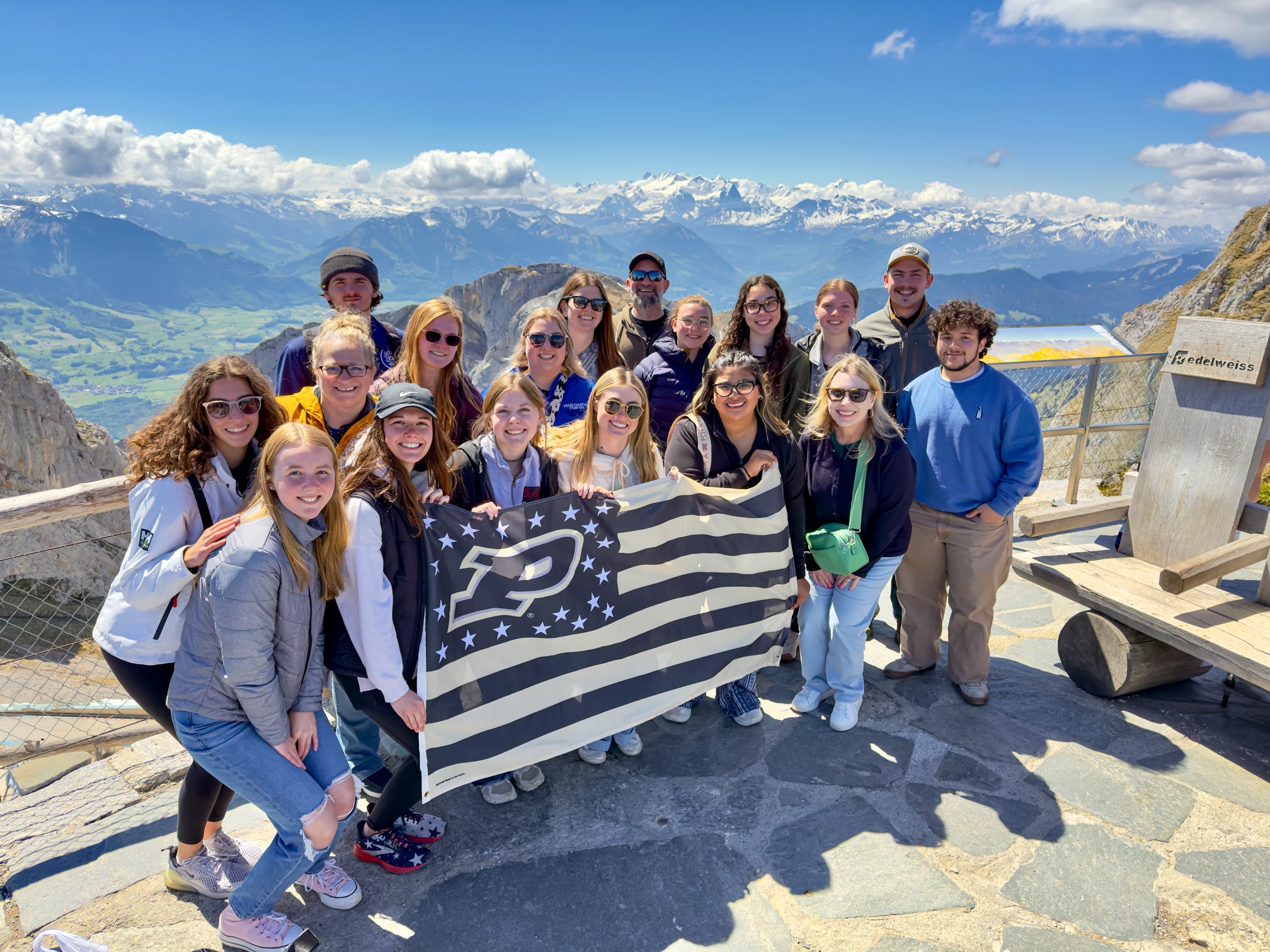 Group with the Purdue flag by the mountains
