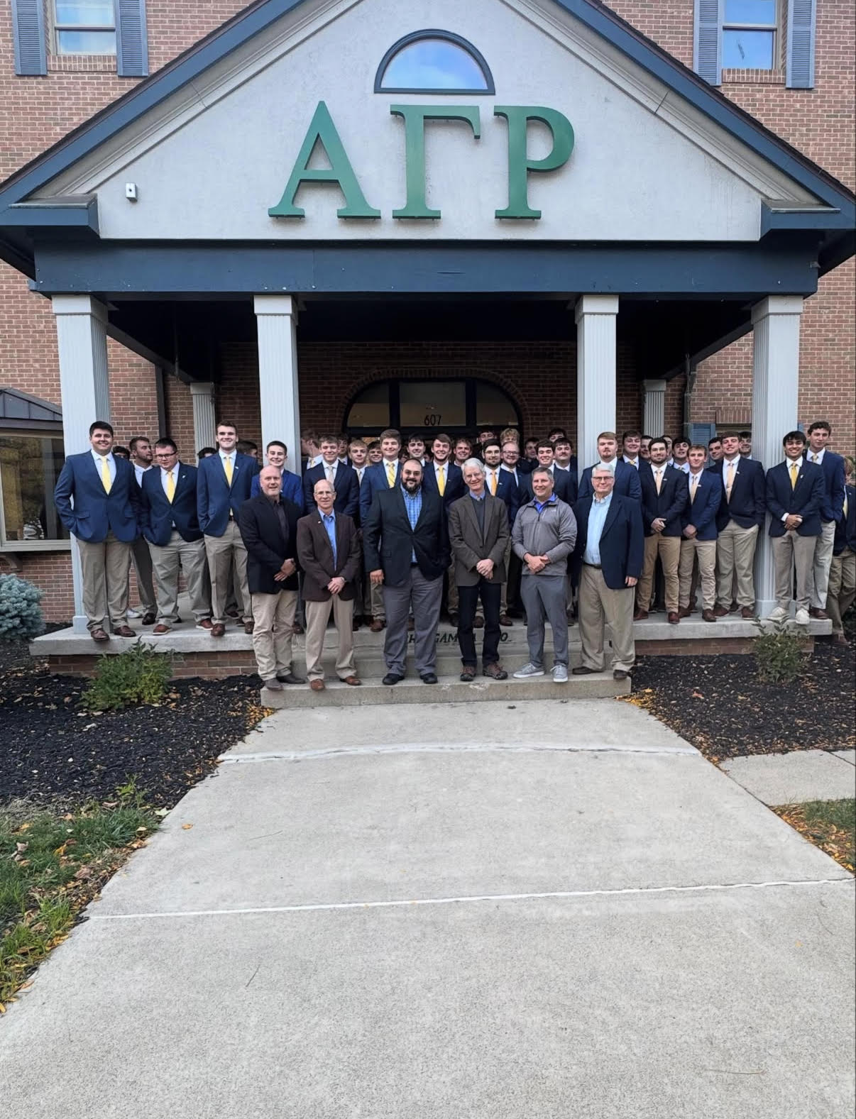 group photo of agr fraternity brothers in front of the house
