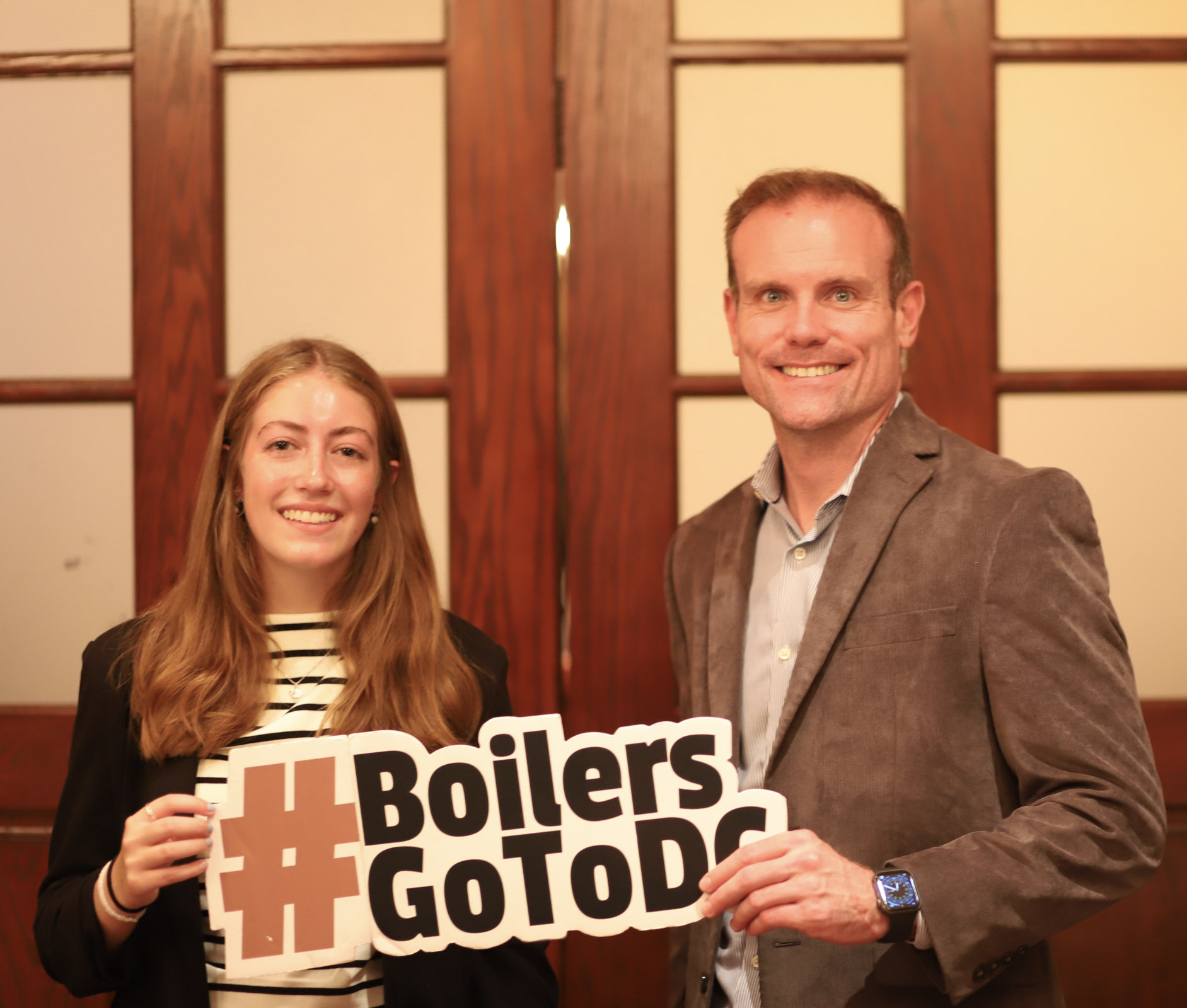 Emma standing with a Purdue alum