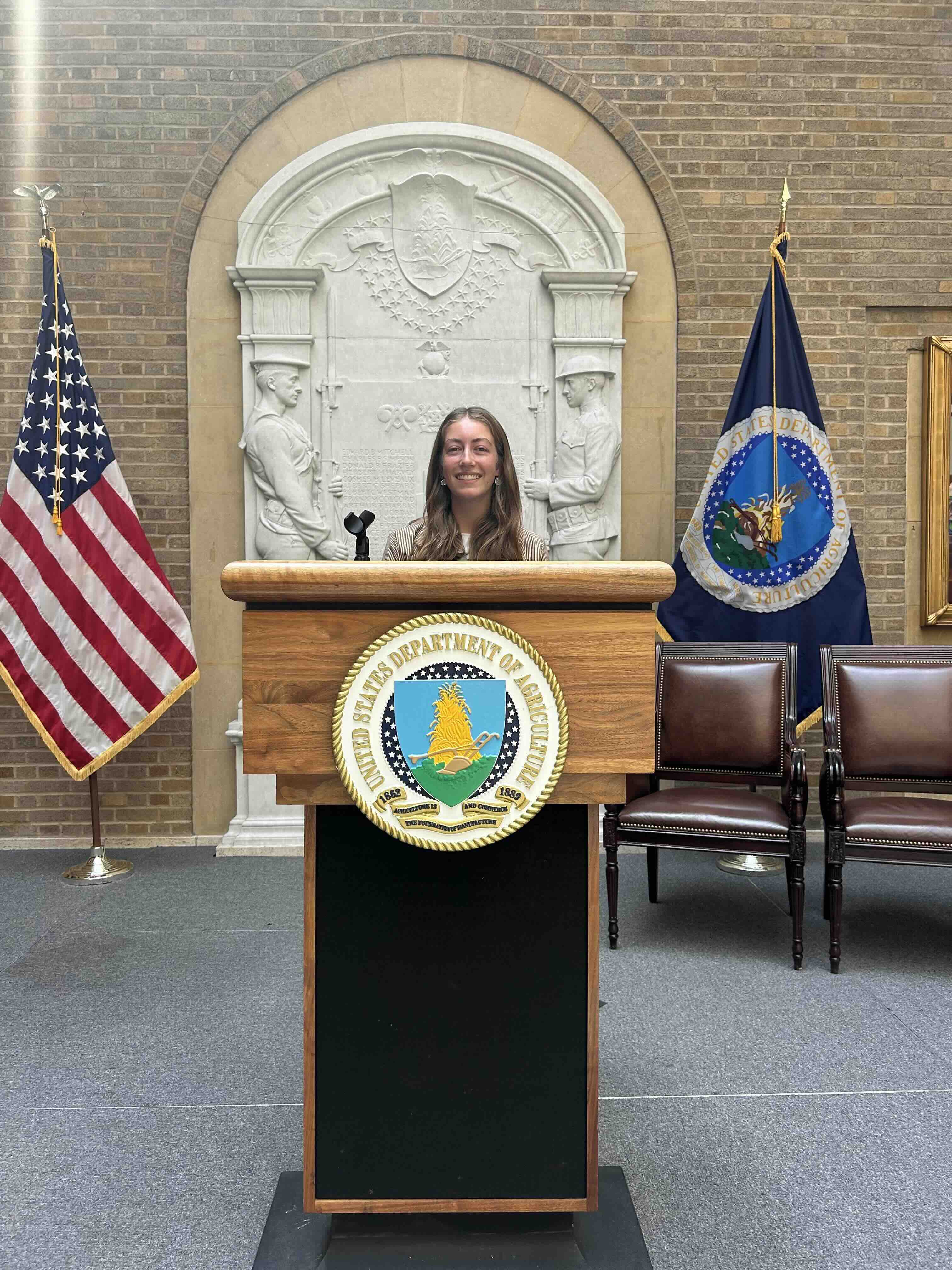 Emma standing behind the USDA podium